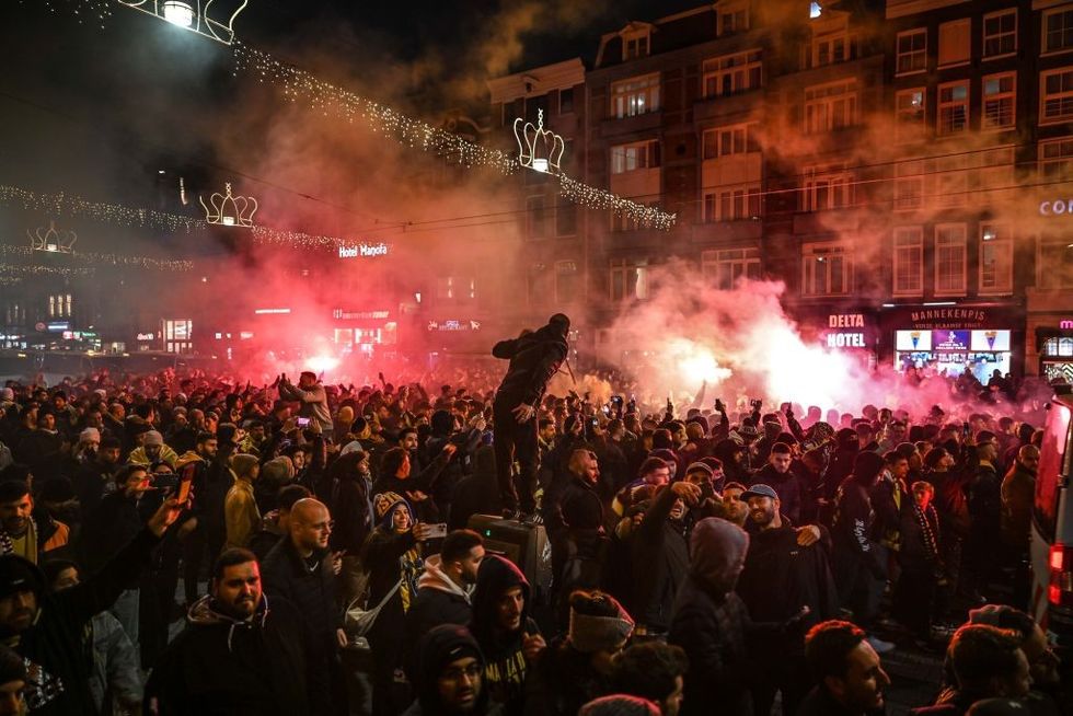 u200bFans of Maccabi Tel Aviv stage a pro-Israel demonstration at the Dam Square, lighting up flares and chanting slogans