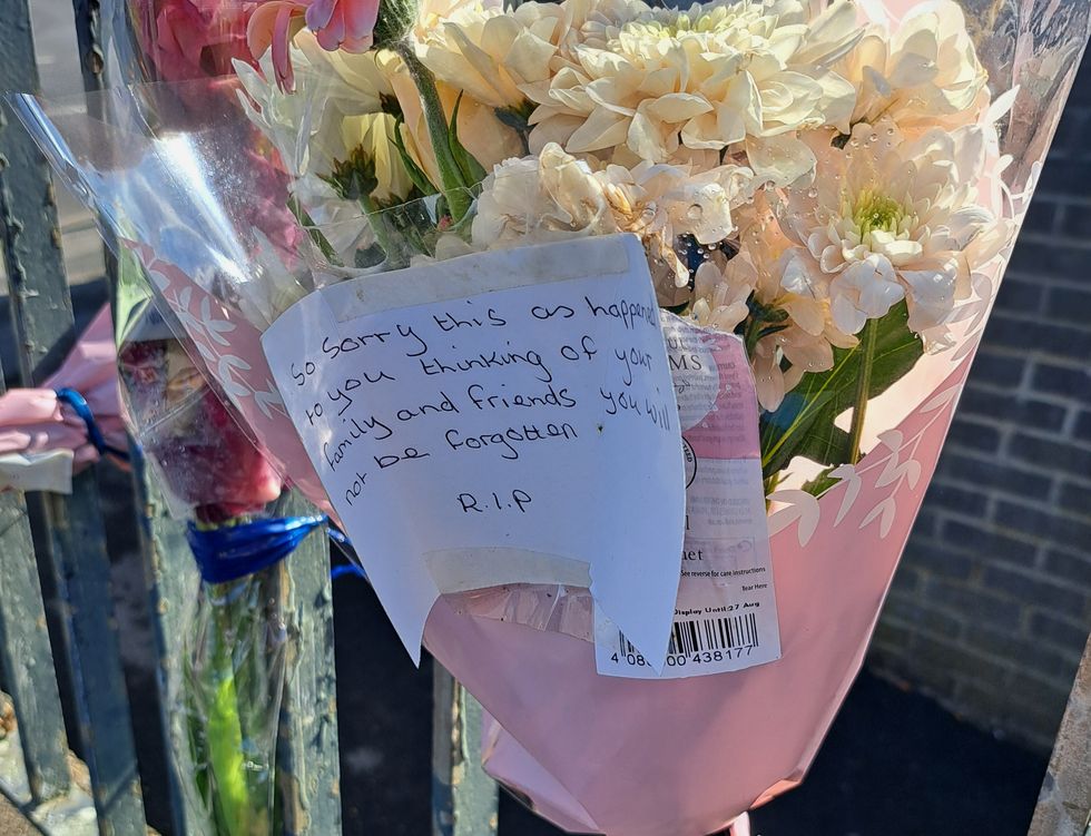 \u200bFloral tributes left the scene he scene in Heights Drive