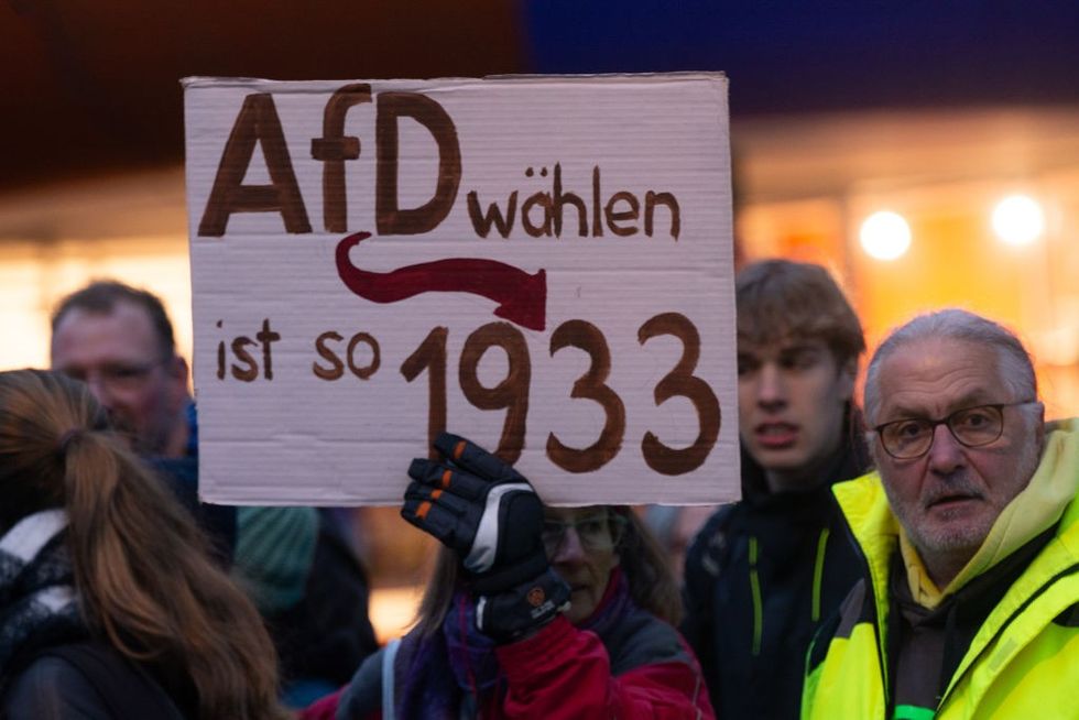 u200bHundreds of protesters hold banners and signs against AFD in front of the Chorweiler Community Center,