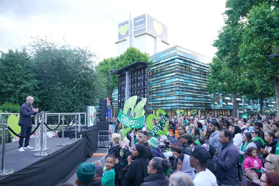 u200bMarcio Gomes of Grenfell United speaks on stage following a silent walk near Grenfell Tower