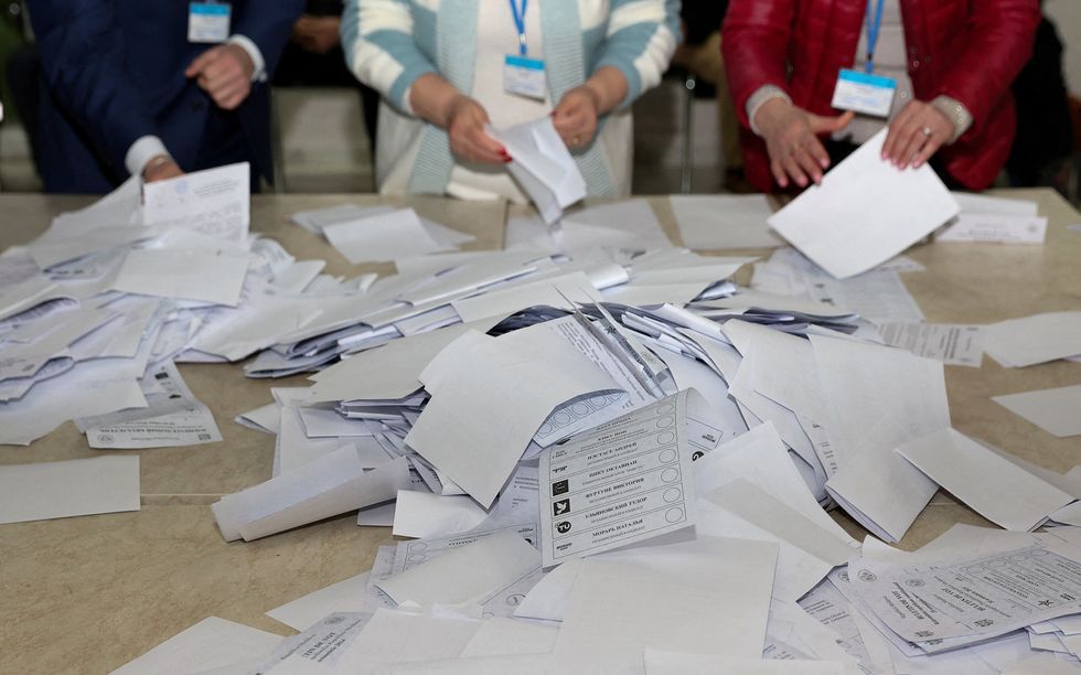 \u200bMembers of an electoral commission count votes after polling stations closed in the course of Moldova's presidential election and a referendum on joining the European Union, in Chisinau,