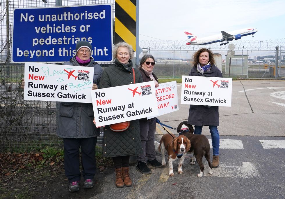 \u200bMembers of CAGNE (Communities Against Gatwick Noise Emissions) stand near the perimeter fence at London Gatwick Airport