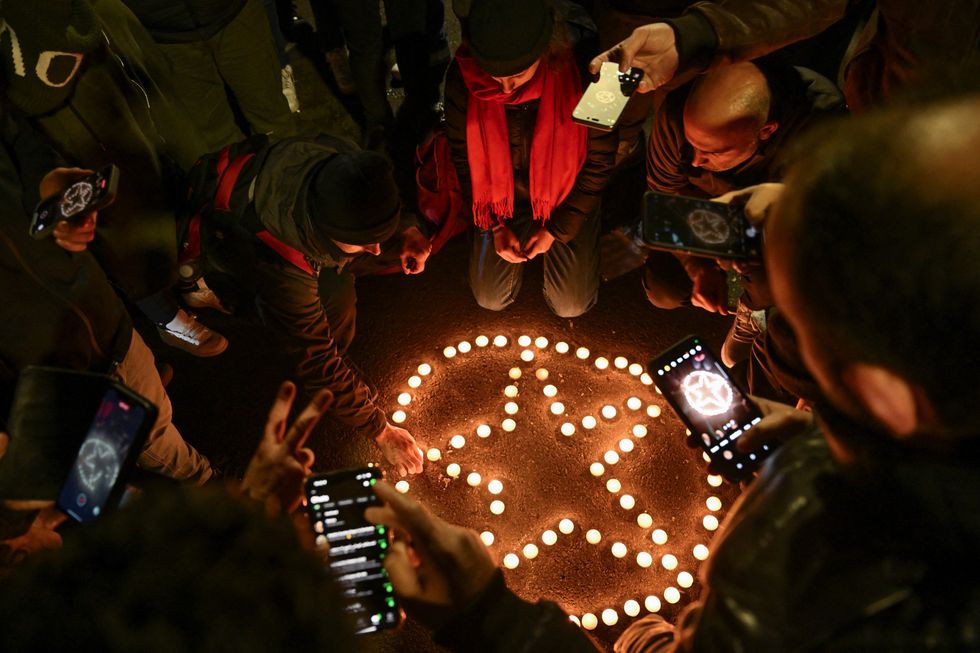 u200bMembers of the Kurdish community and locals light candles arranged to depict the star in the Kurdistan Workers' Party (PKK) flag