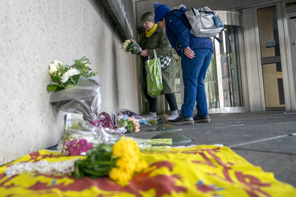 \u200bMembers of the public place flowers outside the Scottish Parliament in Edinburgh for Salmond