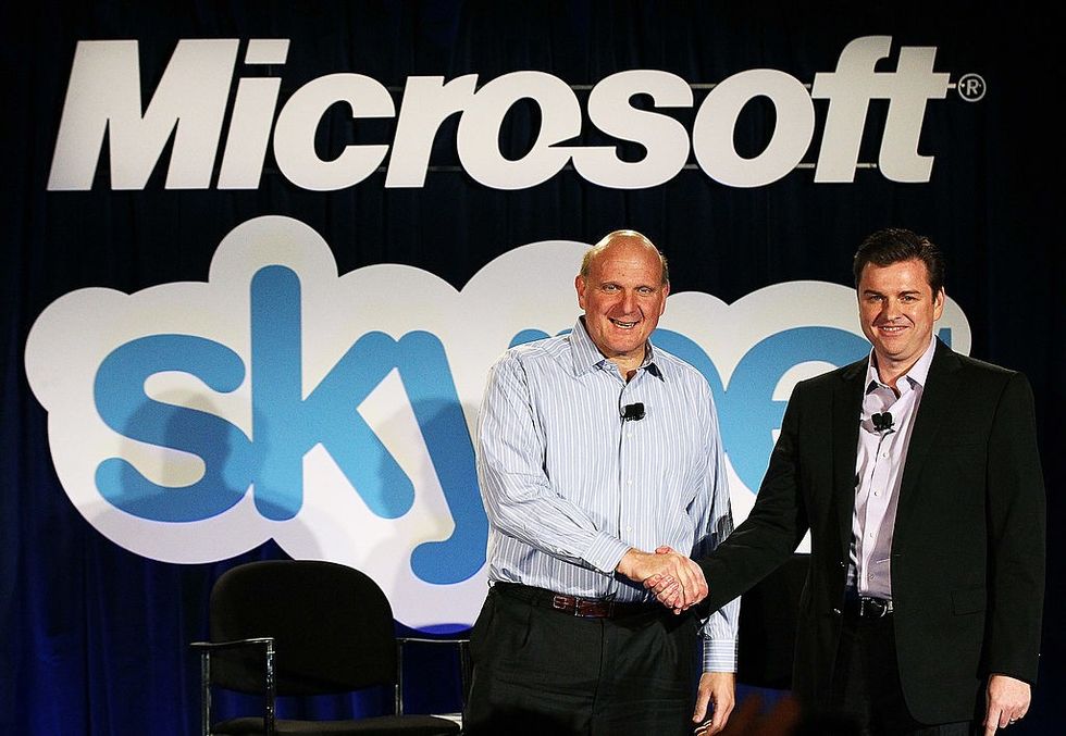 u200bMicrosoft CEO Steve Ballmer (L) shakes hands with Skype CEO Tony Bates following the acquisition in 2011