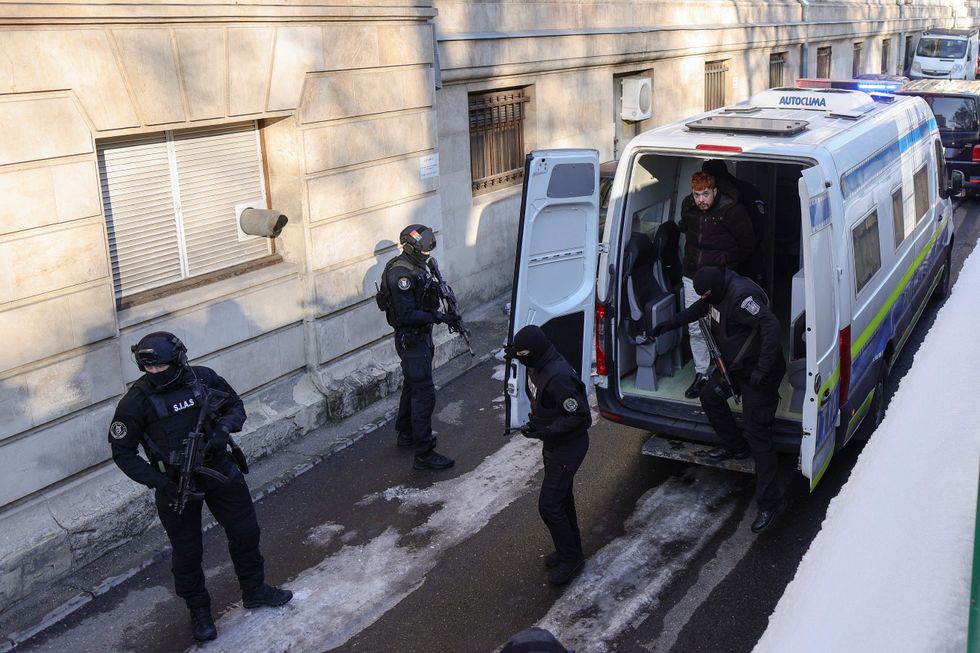 \u200bMohamed Amra is escorted inside the Bucharest Court of Appeal