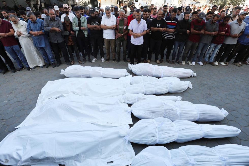 u200bMourners react near the bodies of Palestinians, who were killed in an Israeli strike, amid the Israel-Hamas conflict, at Al-Aqsa Martyrs Hospita