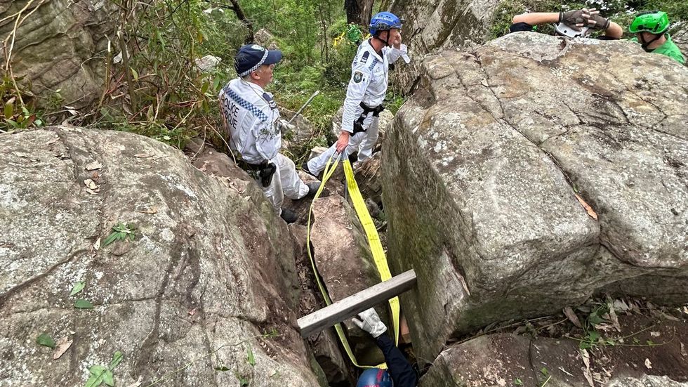 u200bNSW police seen moving a massive boulder to free the woman