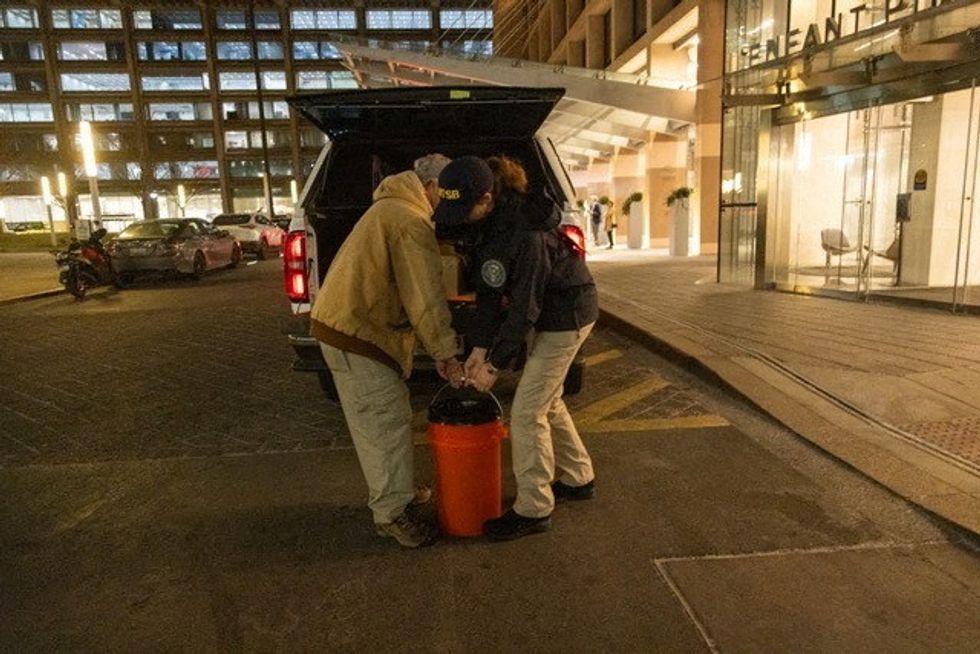 u200bNTSB investigators carry the black box of American Eagle flight 5342