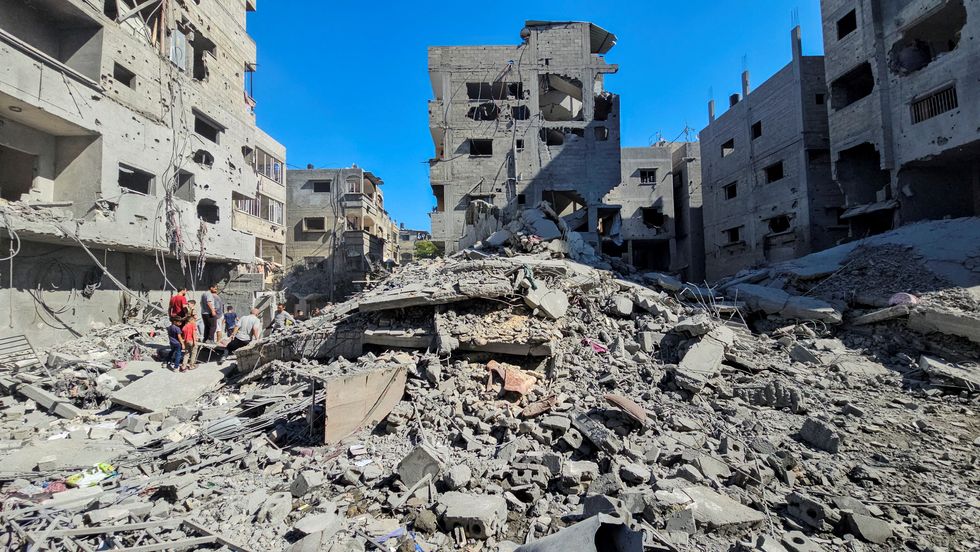 u200bPalestinians gather at the site of Israeli strikes on houses and residential buildings, amid the ongoing Israel-Hamas conflict, in Beit Lahiya