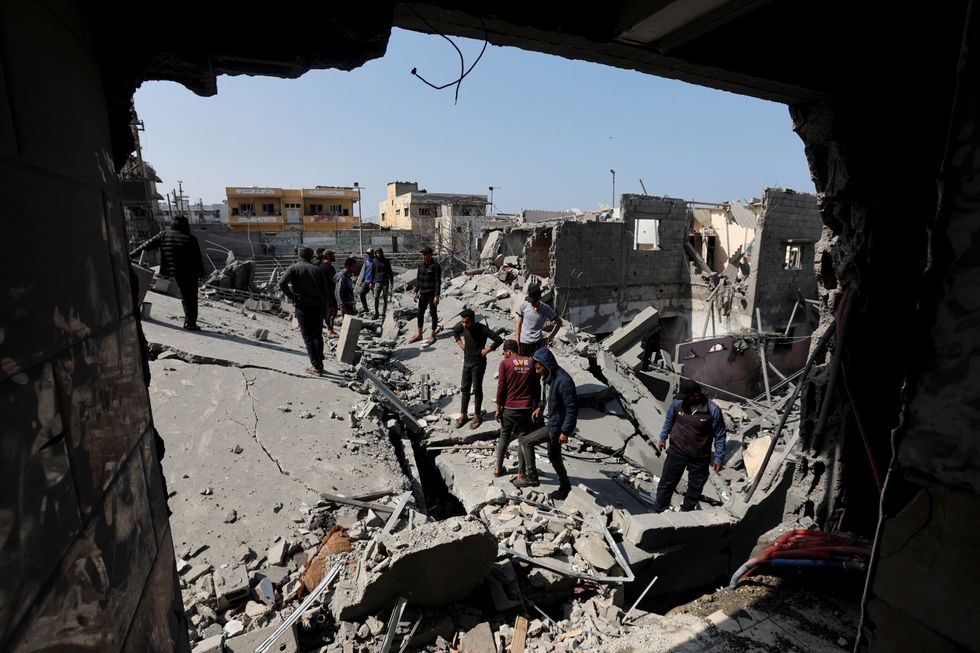 u200bPalestinians inspect the site of an Israeli strike on a residential building, in Deir Al-Balah in the central Gaza Strip