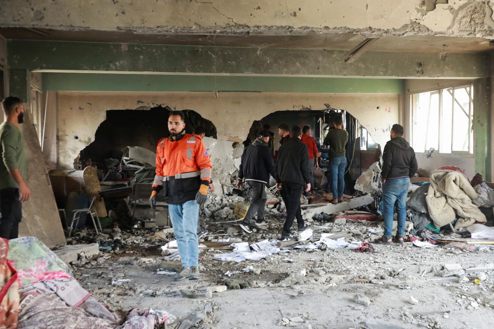 u200bPalestinians inspect the site of an Israeli strike on a school sheltering displaced people