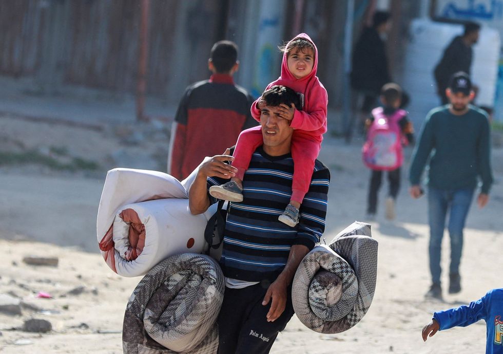 u200bPalestinians make their way to flee their homes, after the Israeli army issued evacuation orders for a number of neighborhoods