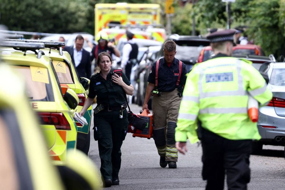 u200bParamedics and police officers walk near the private Study Prep girls' school