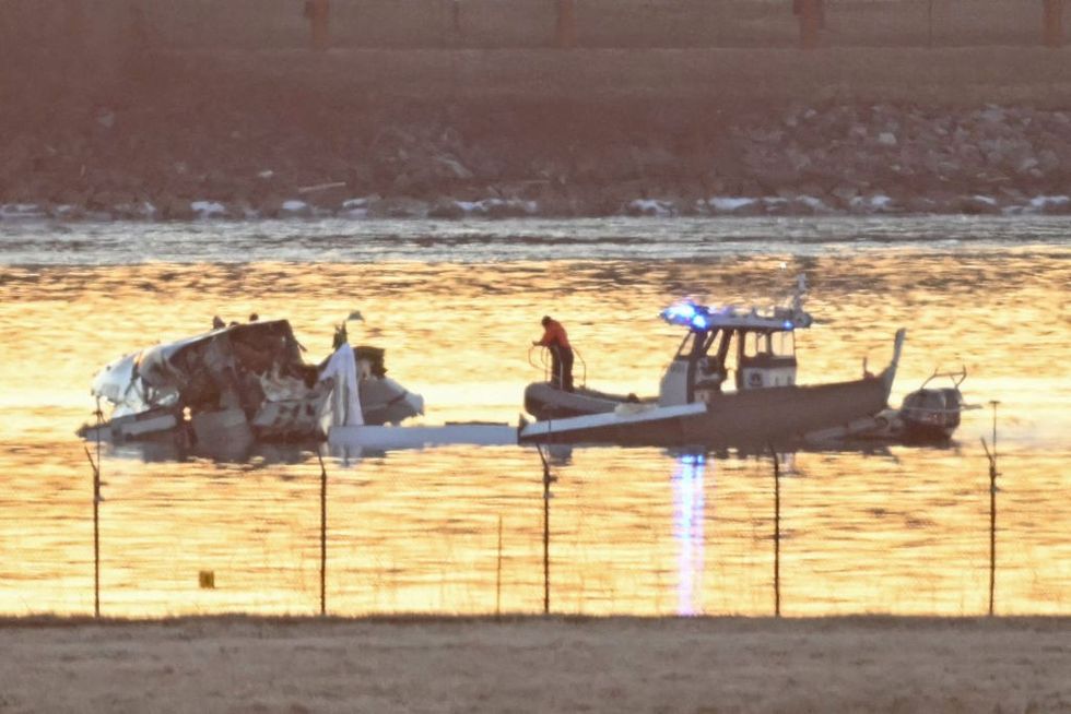 u200bPart of the wreckage is seen as rescue boats search the waters