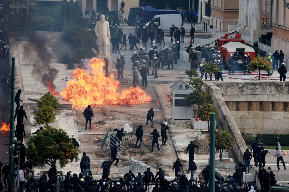 \u200bPeople clash with police near the Greek parliament at a protest