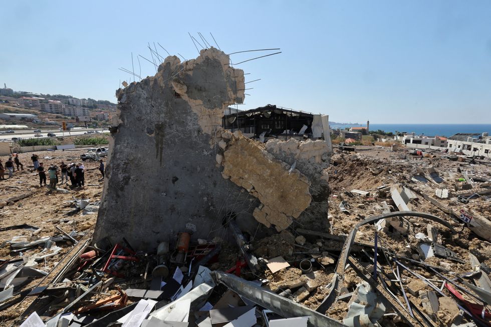 u200bPeople inspect the damage at the site of an Israeli strike that hit the Lebanese seaside town of Jiyeh