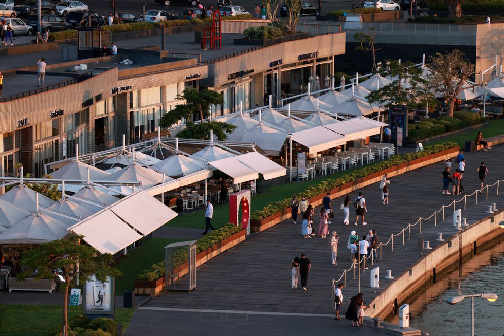 u200bPeople walk near restaurants in Zaitunay Bay, Beirut