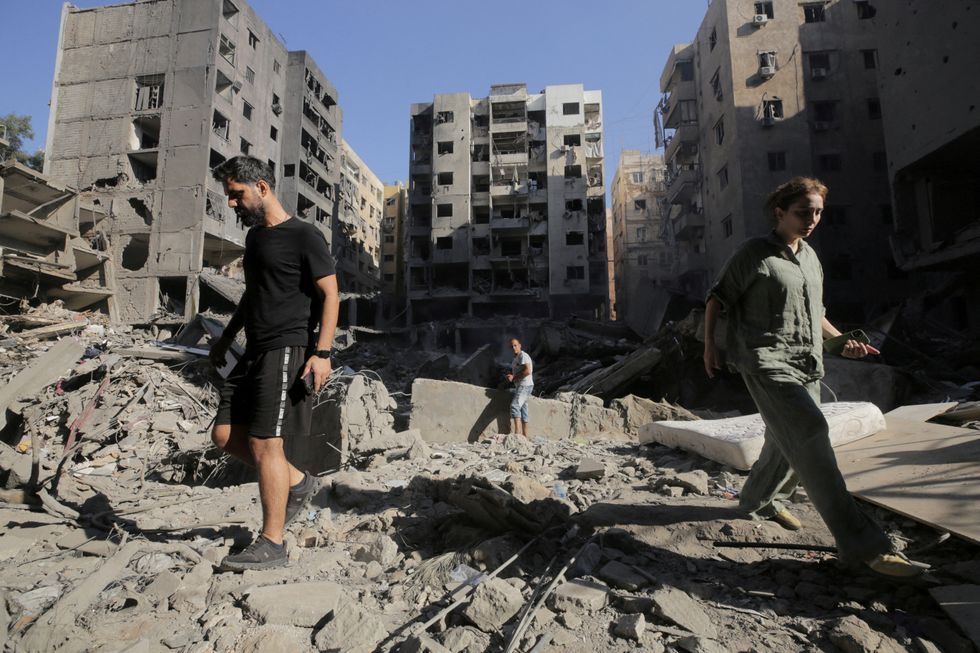 \u200bPeople walk on the rubble at the site of the Israeli airstrike that killed Lebanon's Hezbollah leader Sayyed Hassan Nasrallah