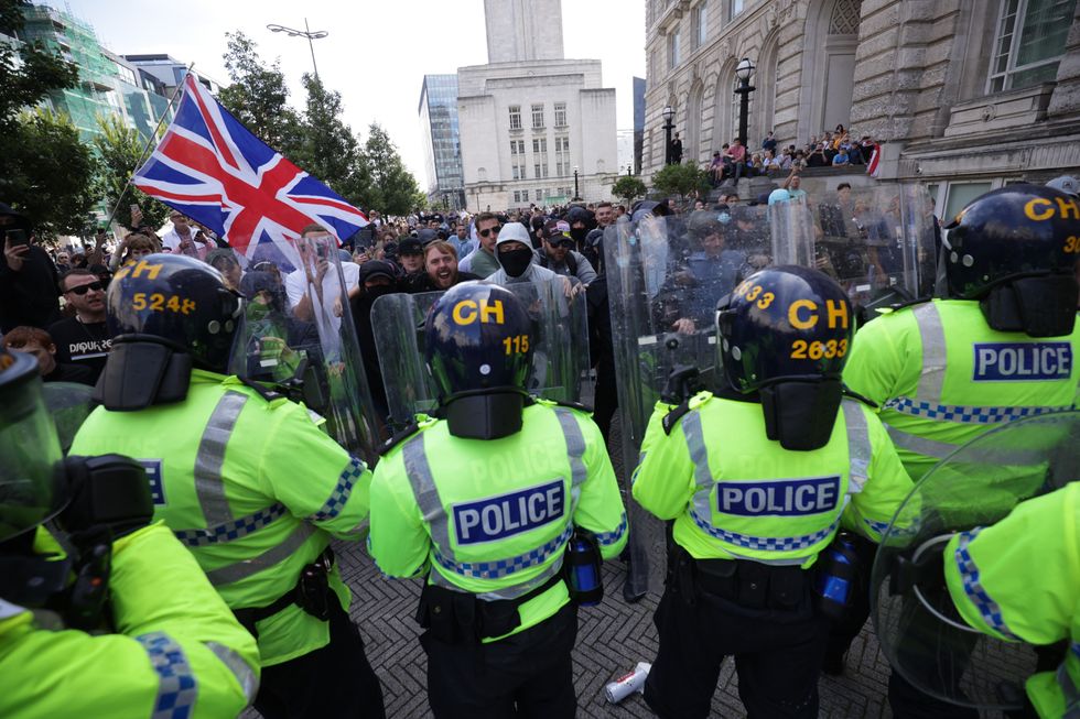 u200bPolice officers face rioters in Liverpool