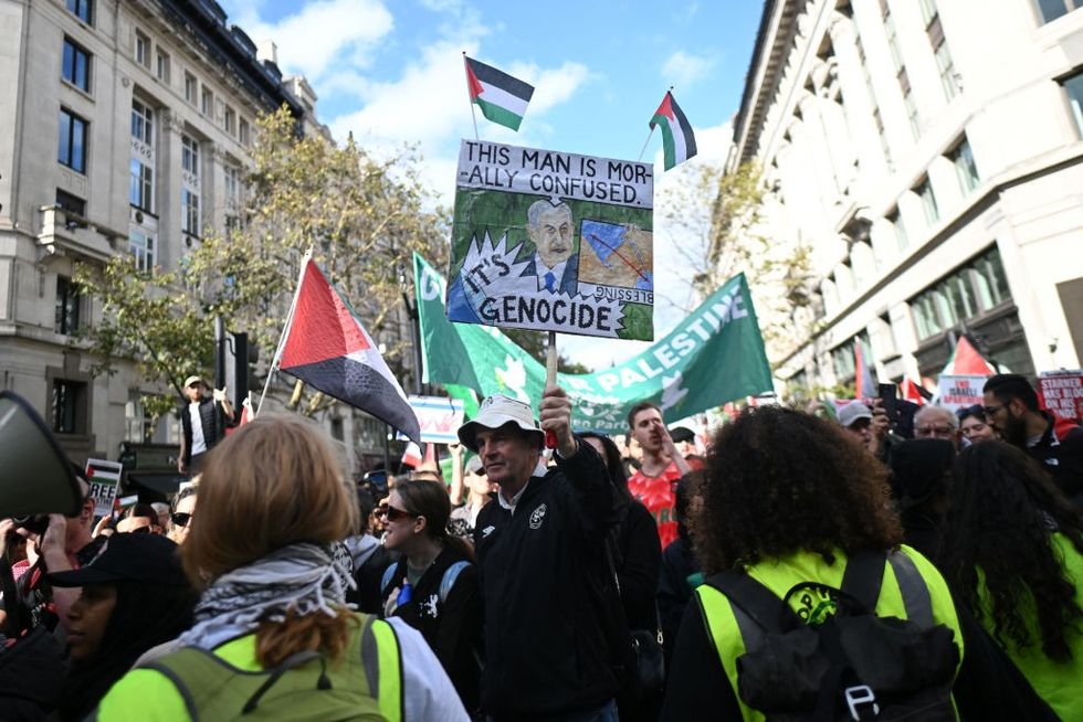 u200bPro-Palestinian activists and supporters wave flags and hold placards as they pass through central London, during a March for Palestine on October 5, 2024