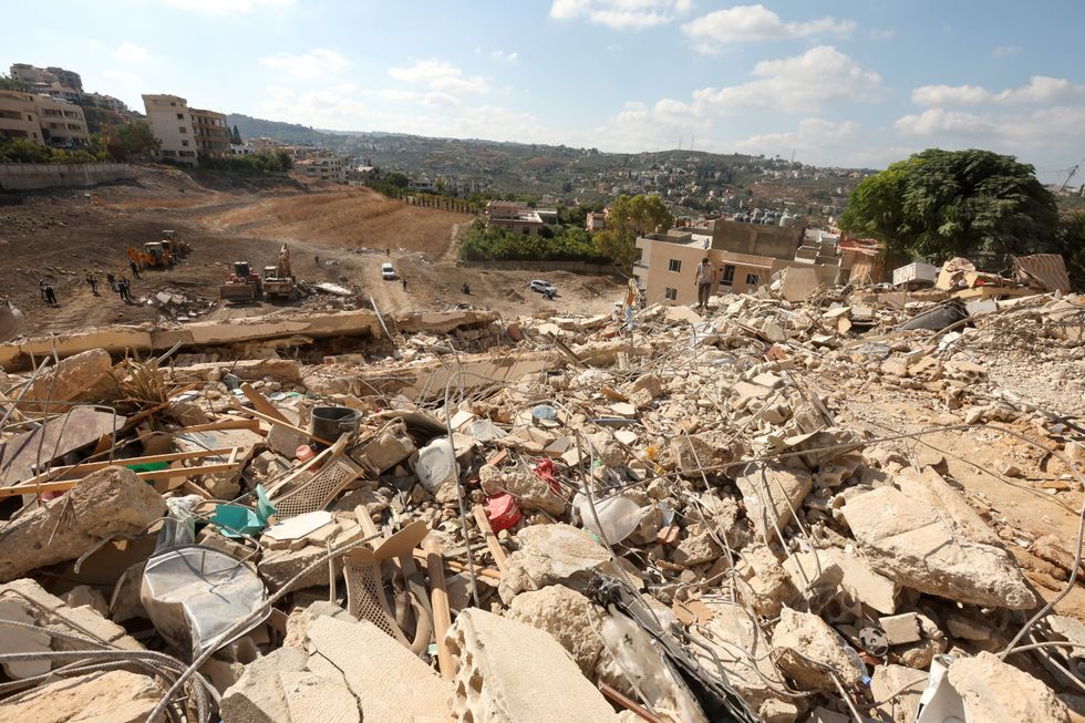 \u200bRescuers work at the site of Sunday's Israeli attack on the city of Ain Deleb