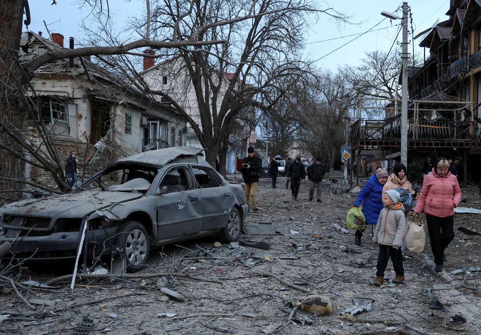 u200bResidents leave from a site of apartment buildings hit by a Russian air strike