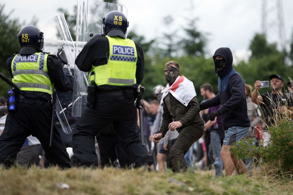 u200bRiot police clash with far-right protesters outside of the Holiday Inn Express in Manvers