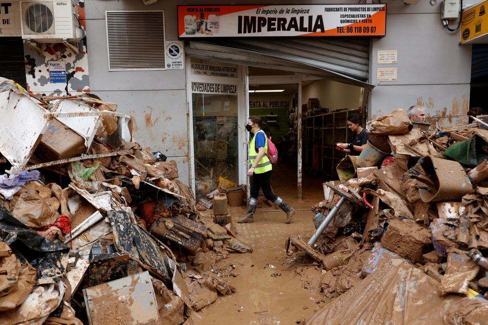 u200bRubbish and mud piled high outside shop in Valencia