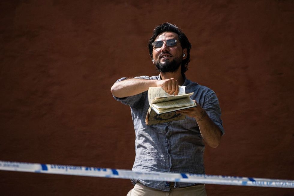 u200bSalwan Momika destroys a copy of the Koran outside a mosque in Stockholm