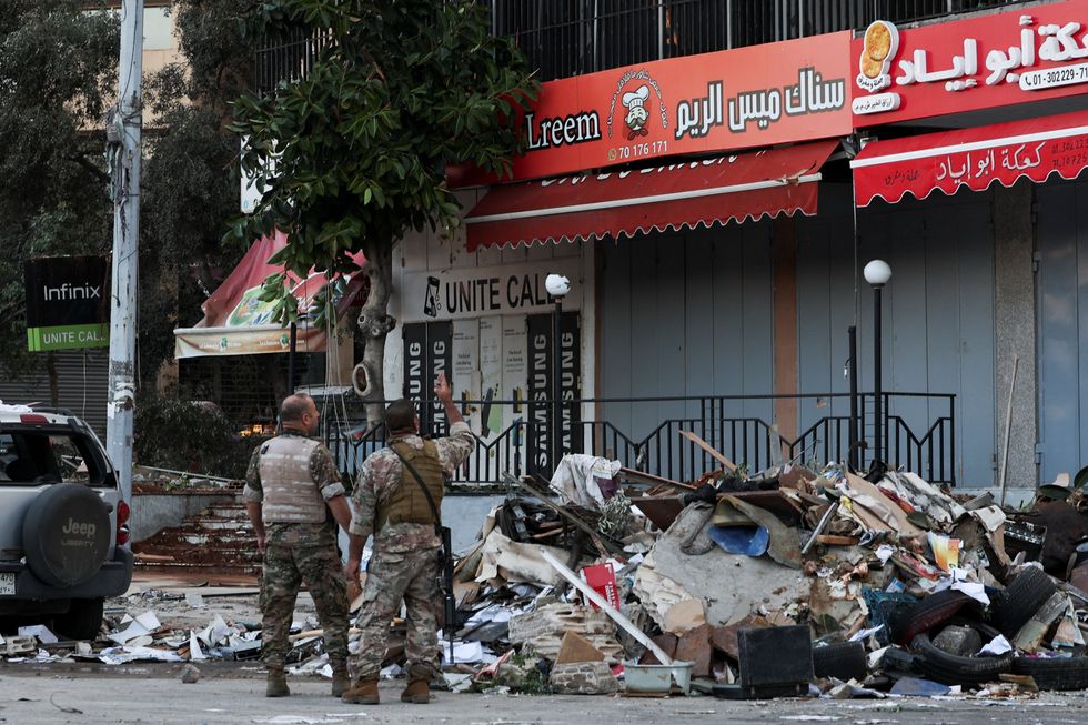 \u200bSecurity personnel inspects a building damaged in an Israeli strike