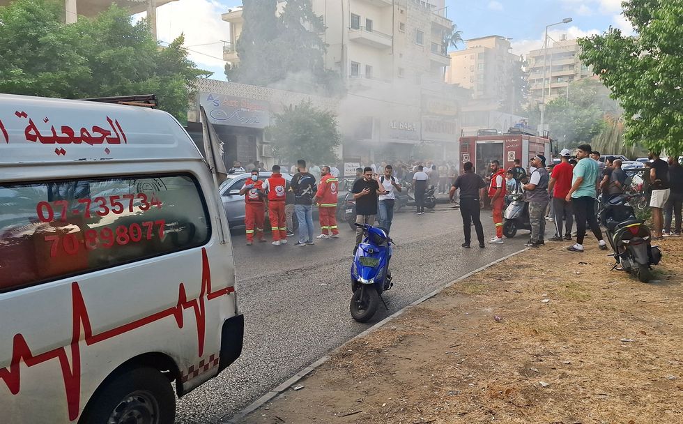 u200bSmoke rises from a mobile shop in Sidon, Lebanon