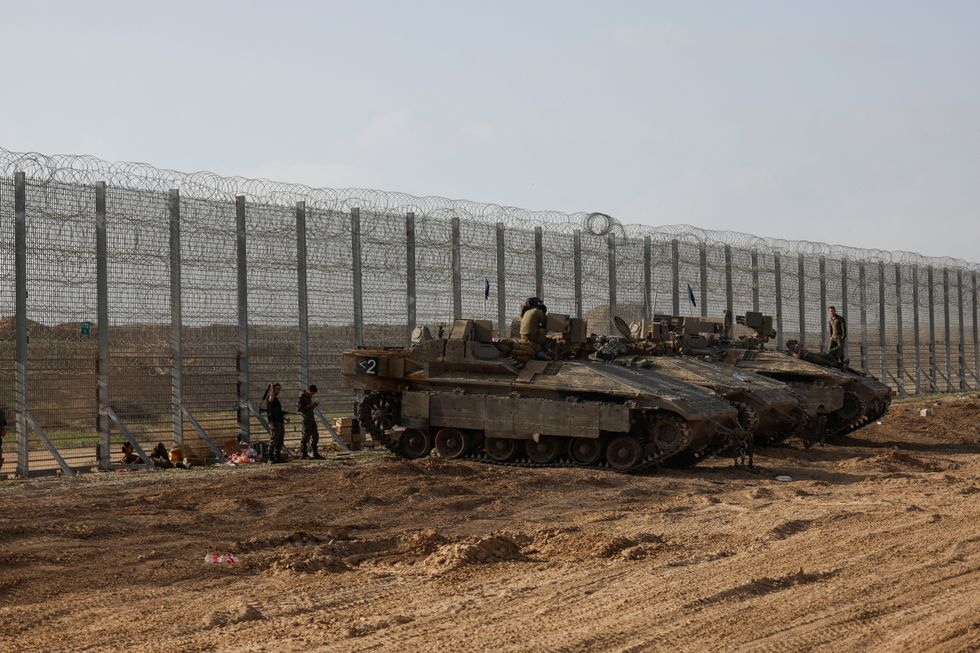 u200bSoldiers sit on top of APC's, at the Israel-Gaza border, in Israel