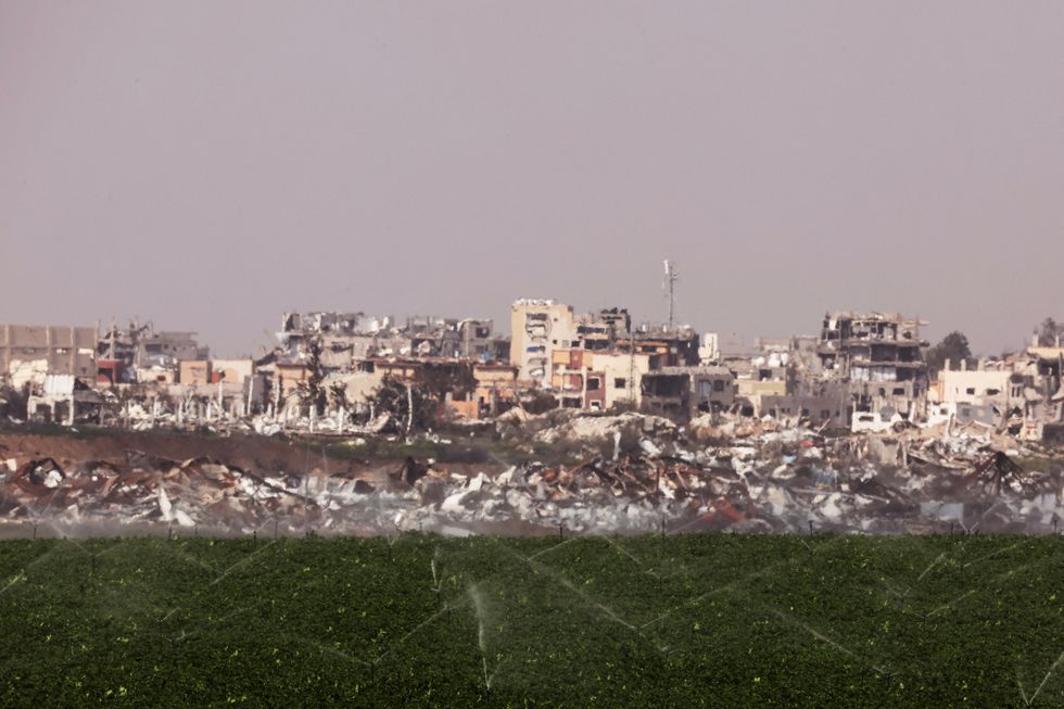 \u200bSprinklers water a field on the Israeli side of the Israel Gaza border, as seen from southern Israe