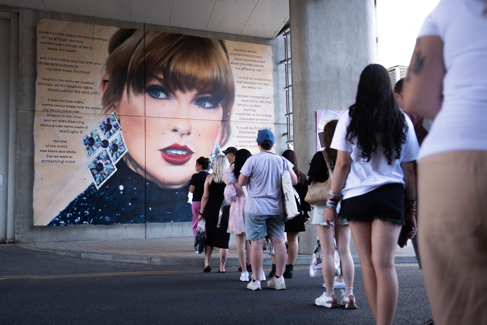 u200bSwifties line up to pose in front of a mural outside Wembley