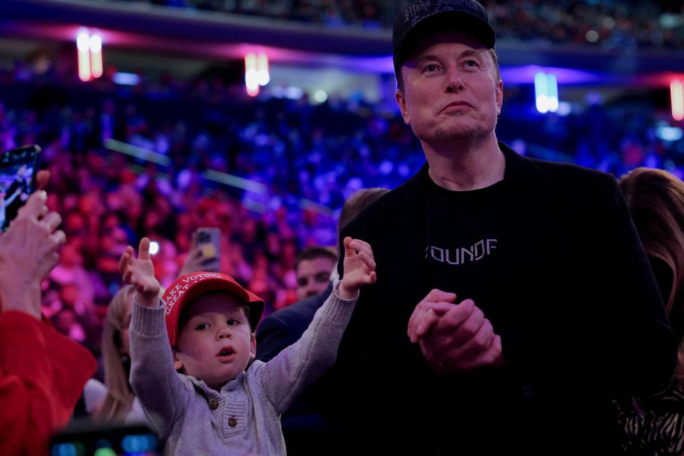 \u200bTesla CEO and X owner Elon Musk stands next to his son during a rally for Donald Trump