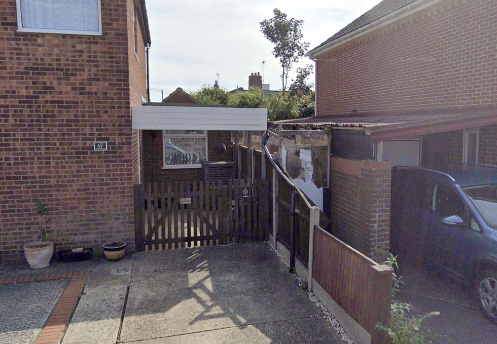 u200bThe entrance to the alleyway with the boarded up door visible