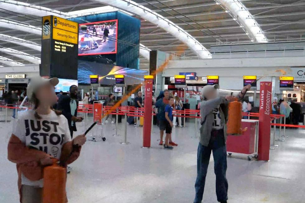 u200bThe pair spraying paint across the terminal building