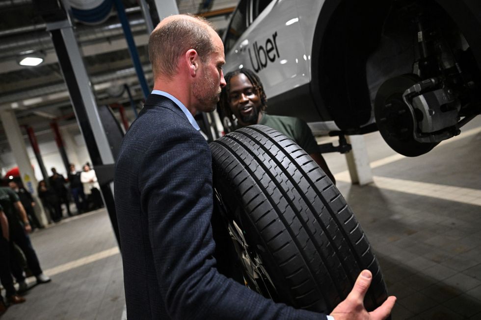 u200bThe Prince of Wales holding a car tyre during a visit to the 2023 Earthshot Prize Finalist, ENSO, in Brentford, west London