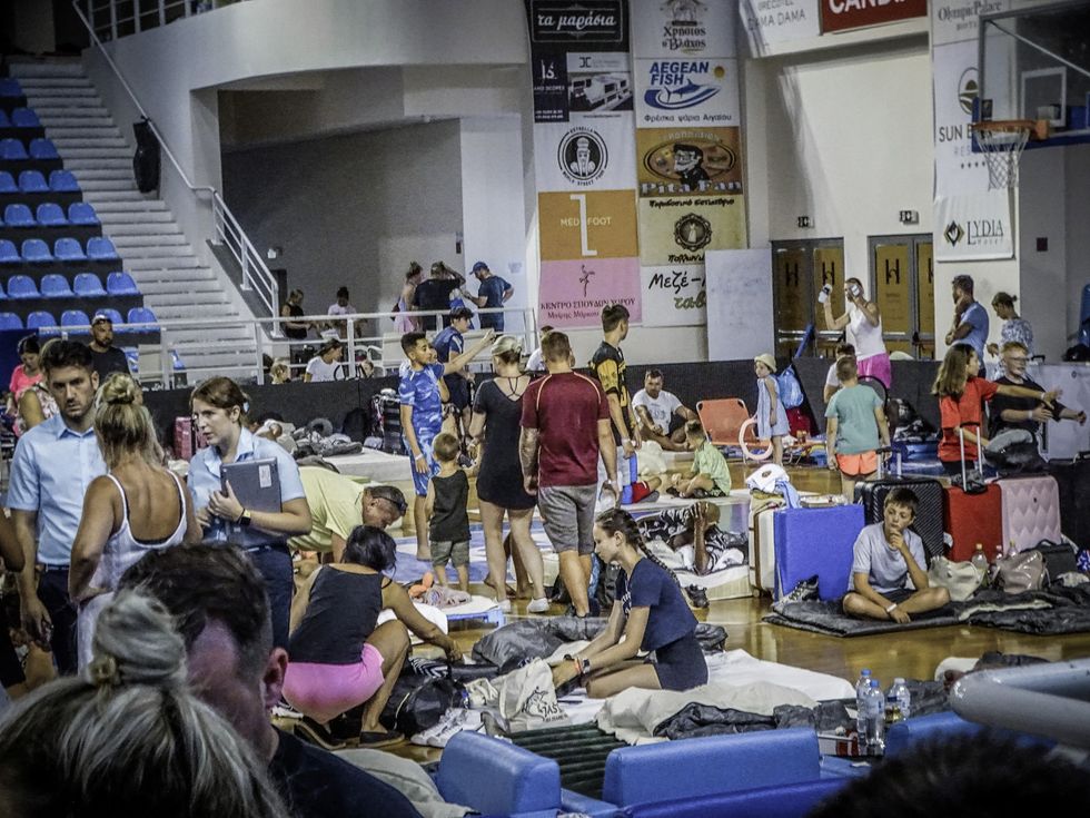 \u200bTourists sheltering in a stadium