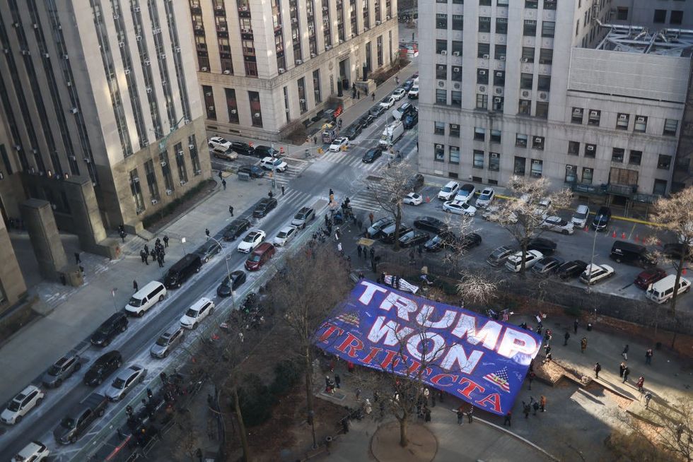 u200bTrump supporters display a giant flag outside the Manhattan Criminal Court in New York,