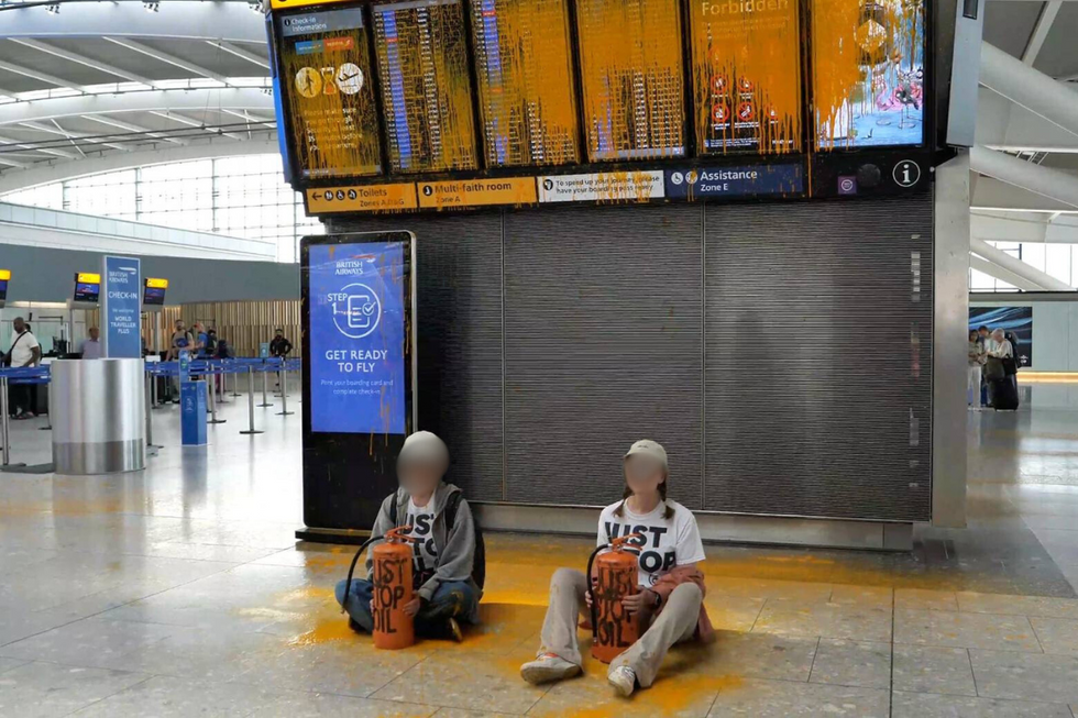 u200bTwo protesters sat in the terminal building