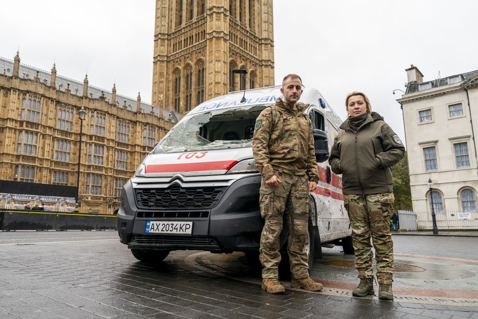 \u200bUkrainian frontline medics Iryna Knyzhnyk and Brandon Mitchell in a war-damaged ambulance