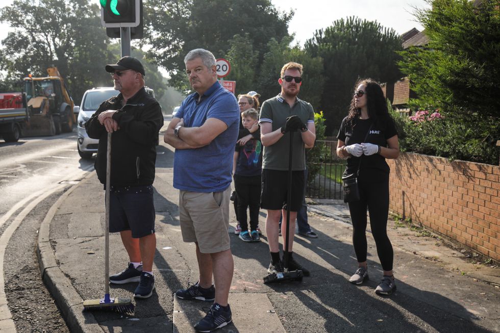 u200bVolunteers sweep Sussex Road in Southport, Merseyside