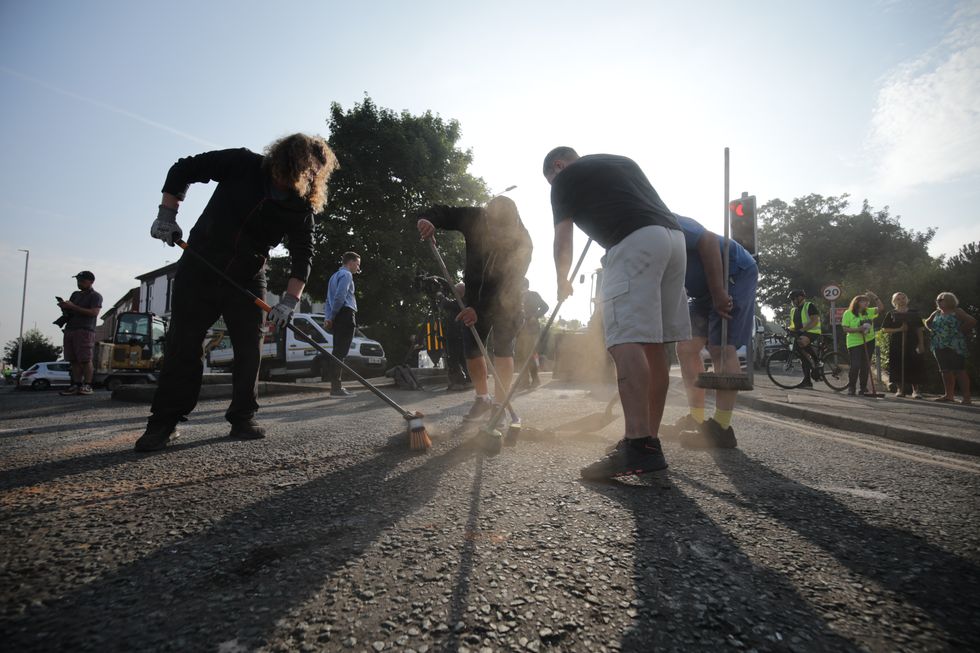 u200bVolunteers sweep Sussex Road in Southport, Merseyside