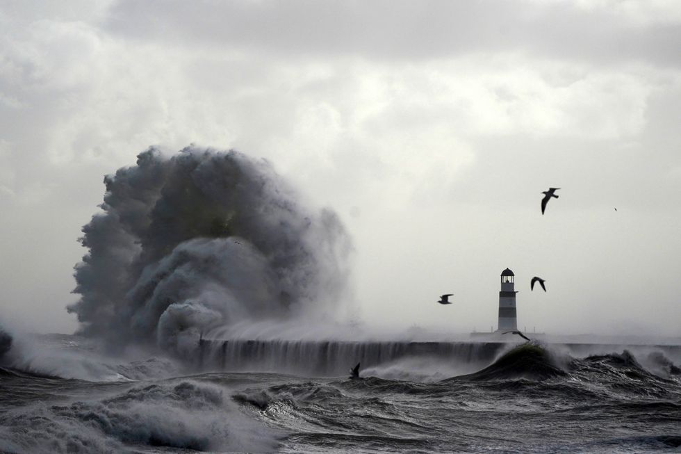 u200bWaves crash against the lighthouse in Seaham Harbour, County Durham