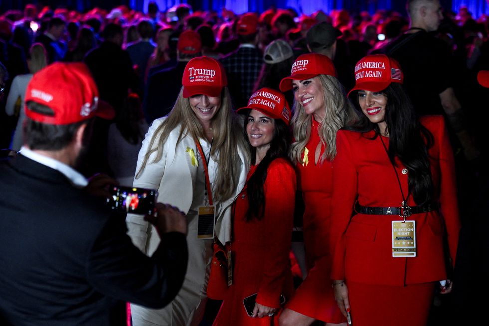 \u200bWomen wearing MAGA (Make America Great Again) hats pose