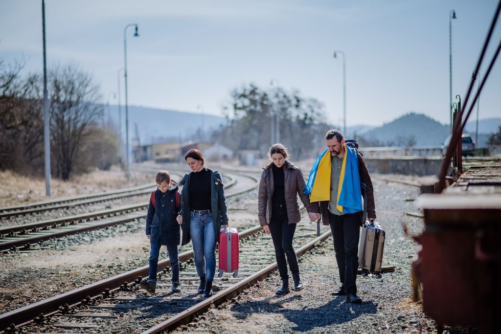 Ukrainian refugee family in station waiting to leave Ukraine due to the Russian invasion of Ukraine