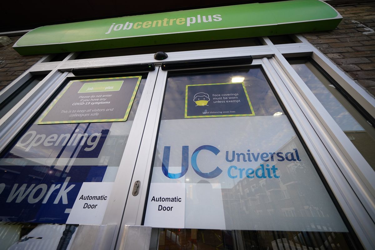 Universal Credit sign on the door of a job centre plus in east London