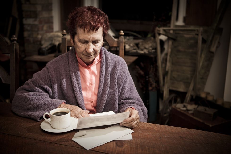 Upset woman looking at bills